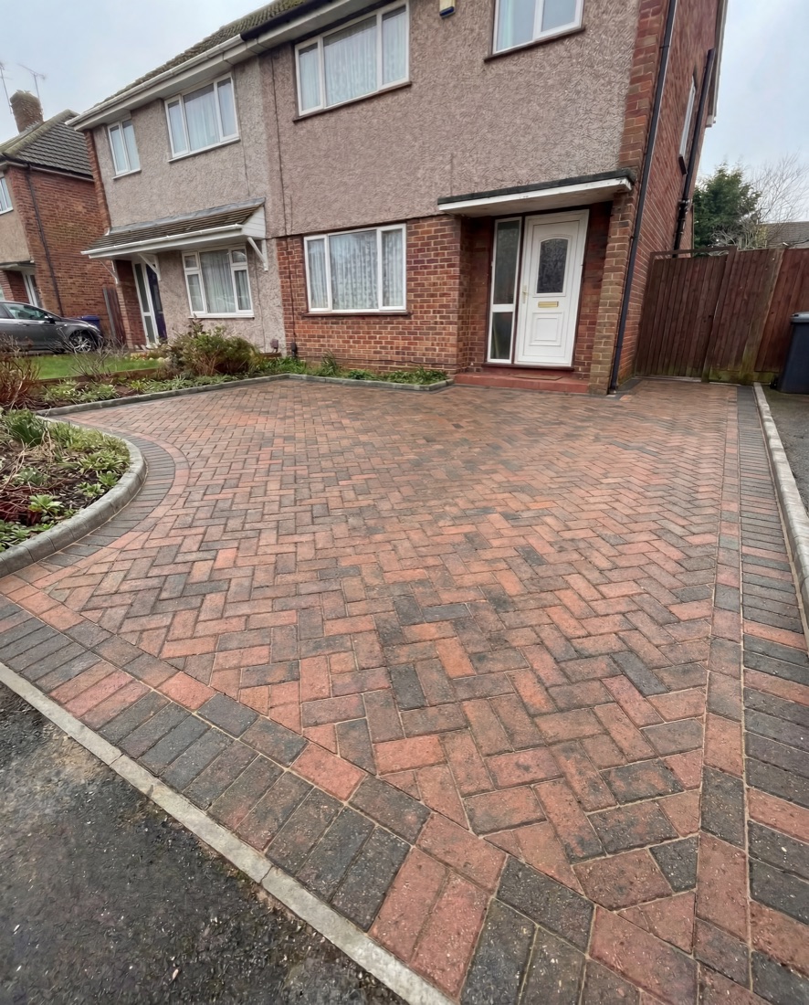 Freshly cleaned herringbone block-paving driveway